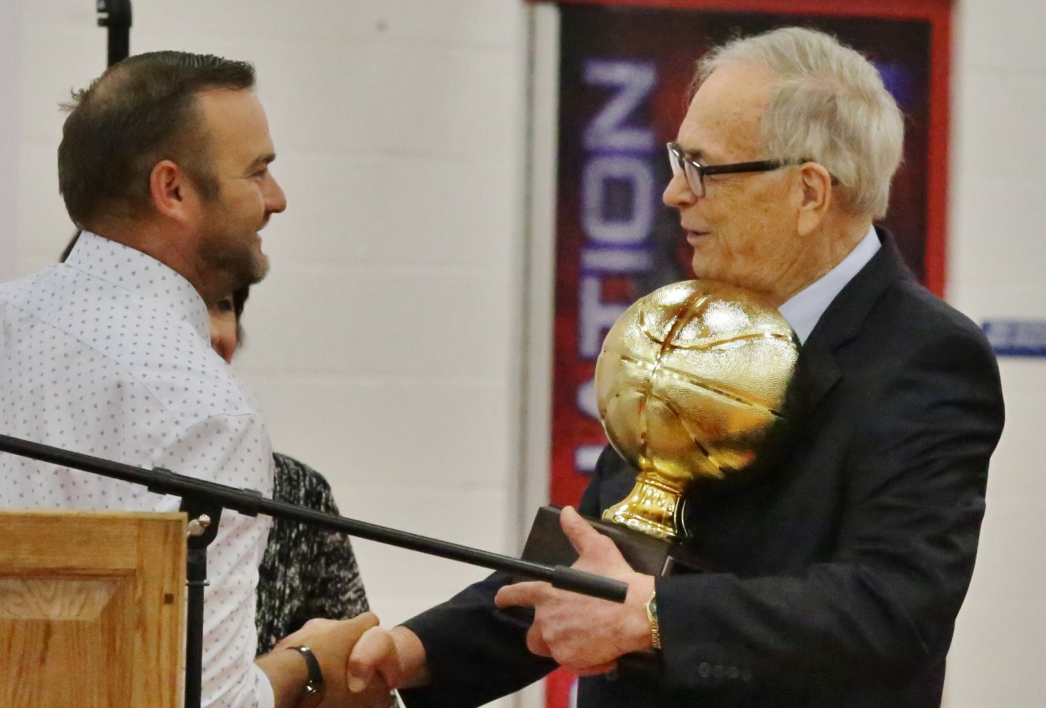 Alba-Golden Athletic Director Drew Webster presents guest speaker and sporting legend Carroll Dawson with a keepsake for his participation at the 2020-21 sports assembly last Wednesday.